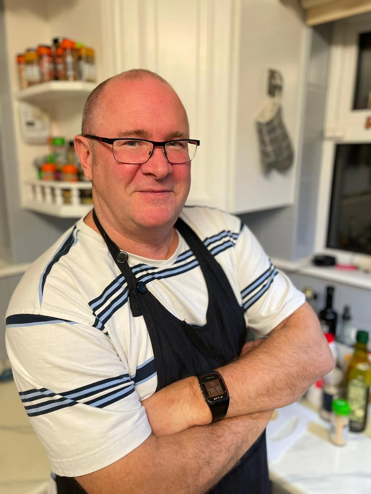 Photograph of Gav in his kitchen with arms crossed.